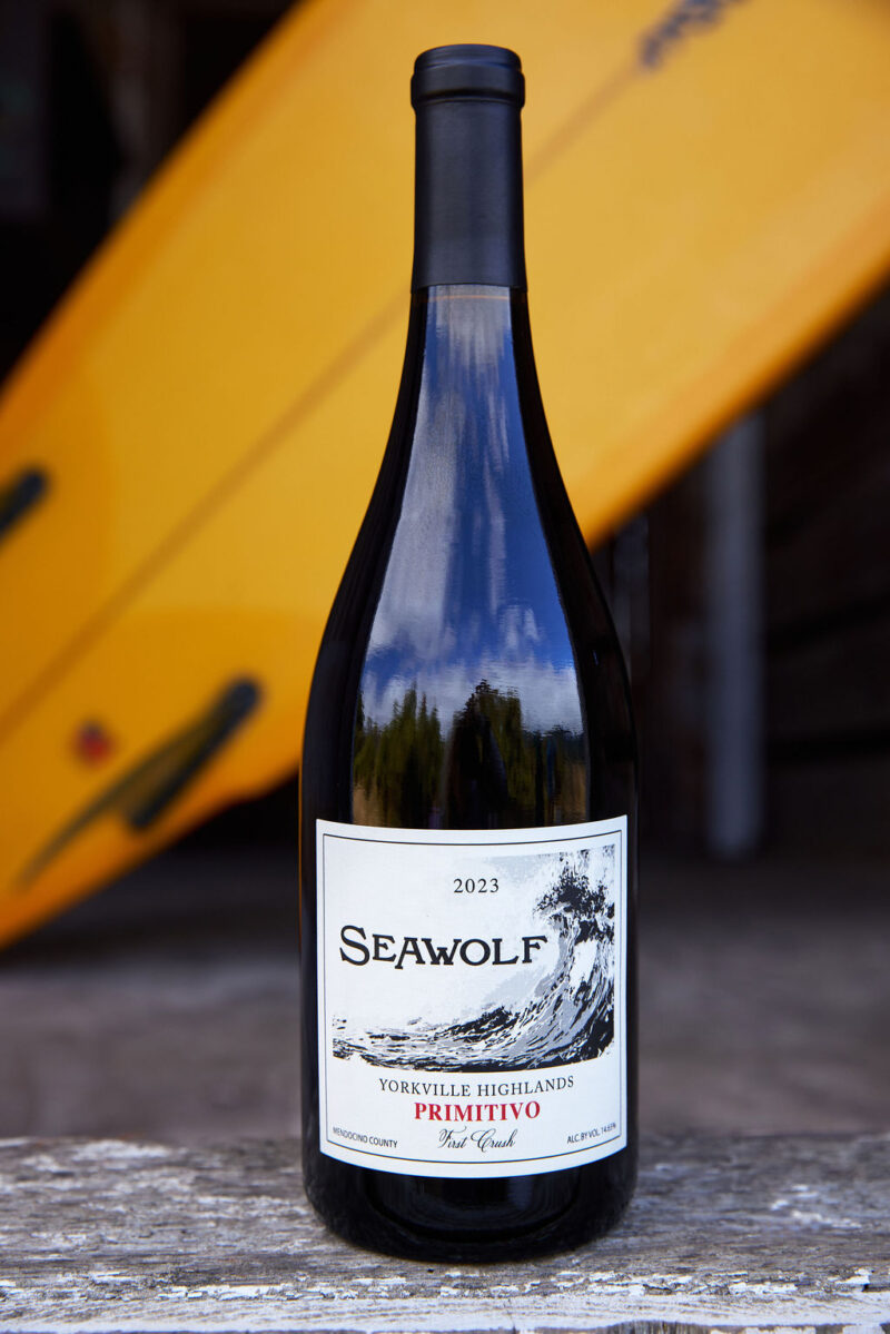 Bottle of Seawolf Primitivo wine with surfboard