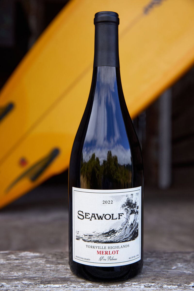 Merlot wine bottle with surfboard background