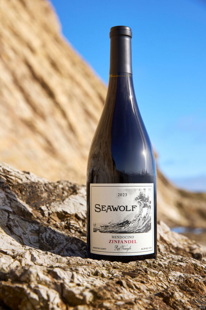 Red Triangle Zinfandel wine bottle on rocky surface